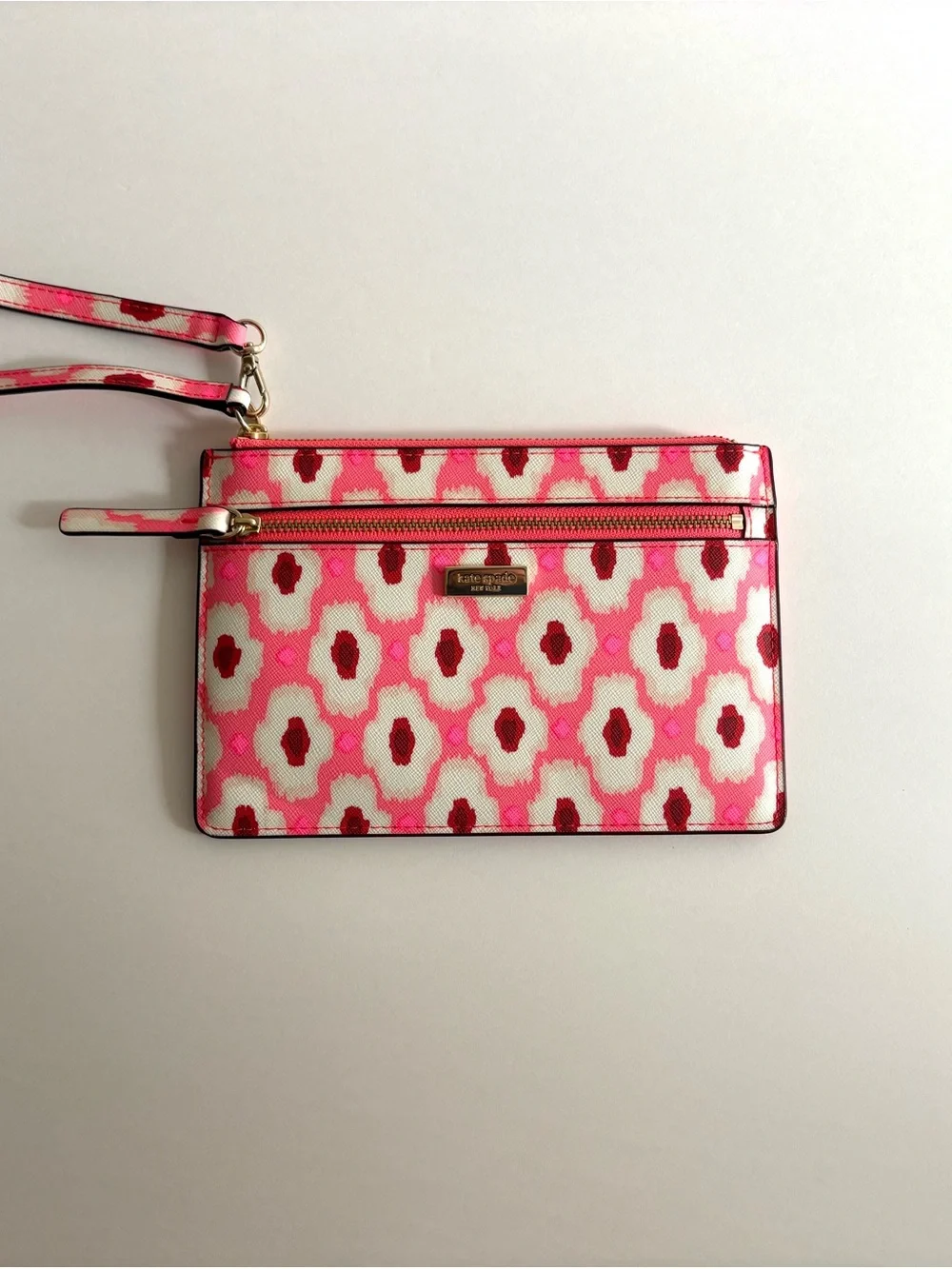kate spade pink and white patterned wristlet clutch with gold hardware